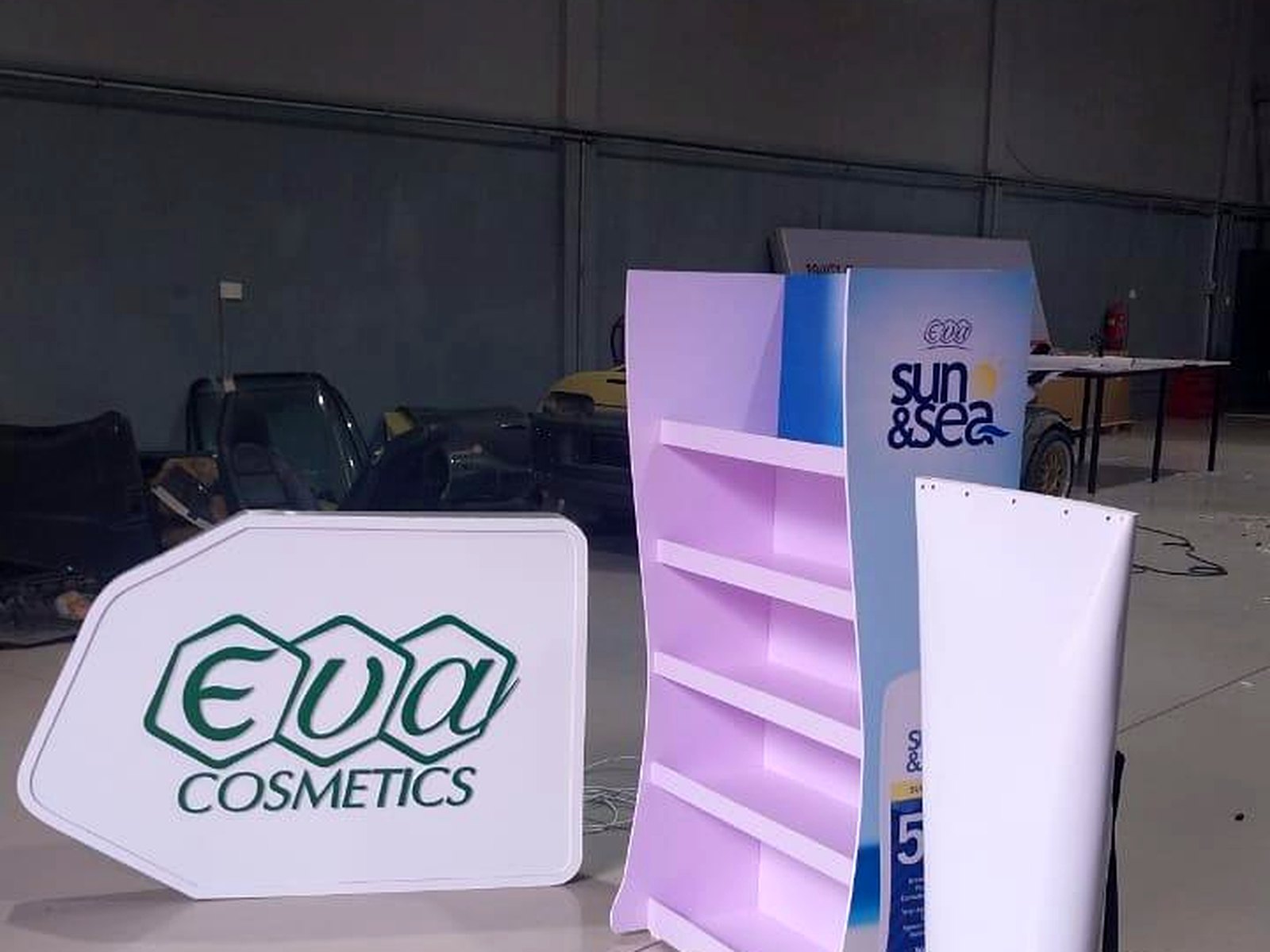 Eva Cosmetics lightbox sign, curved product shelf unit and totem display in the workshop